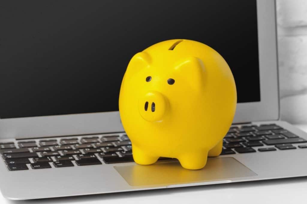 piggybank on laptop keyboard in money saving conce 2025 02 25 10 03 25 utc